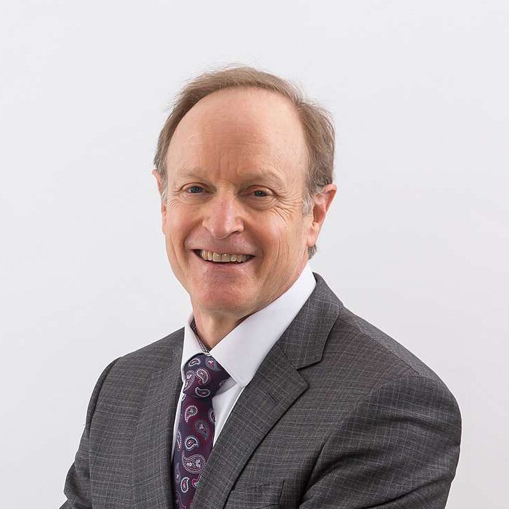 Patrick Gaskin, light brown hair man, grey suit and tie.