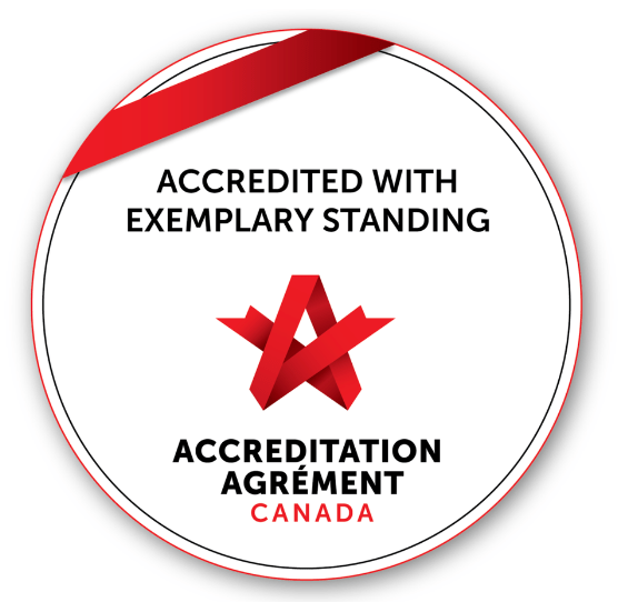 A circular badge showing "Accredited with Exemplary Standing" from Accreditation Canada with a red ribbon and logo.