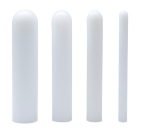 Four white, cylindrical plastic rods of varying heights and thicknesses are arranged upright in a row on a white background.