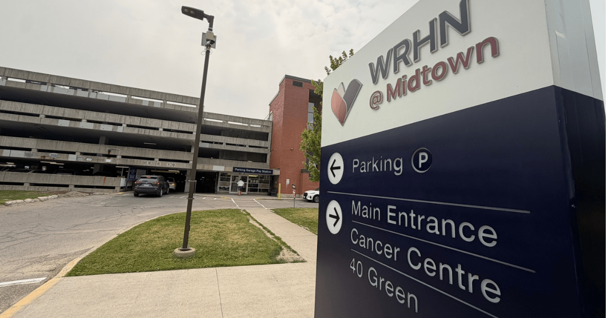 Sign that says WRHN at Midtown with arrow point to Parking