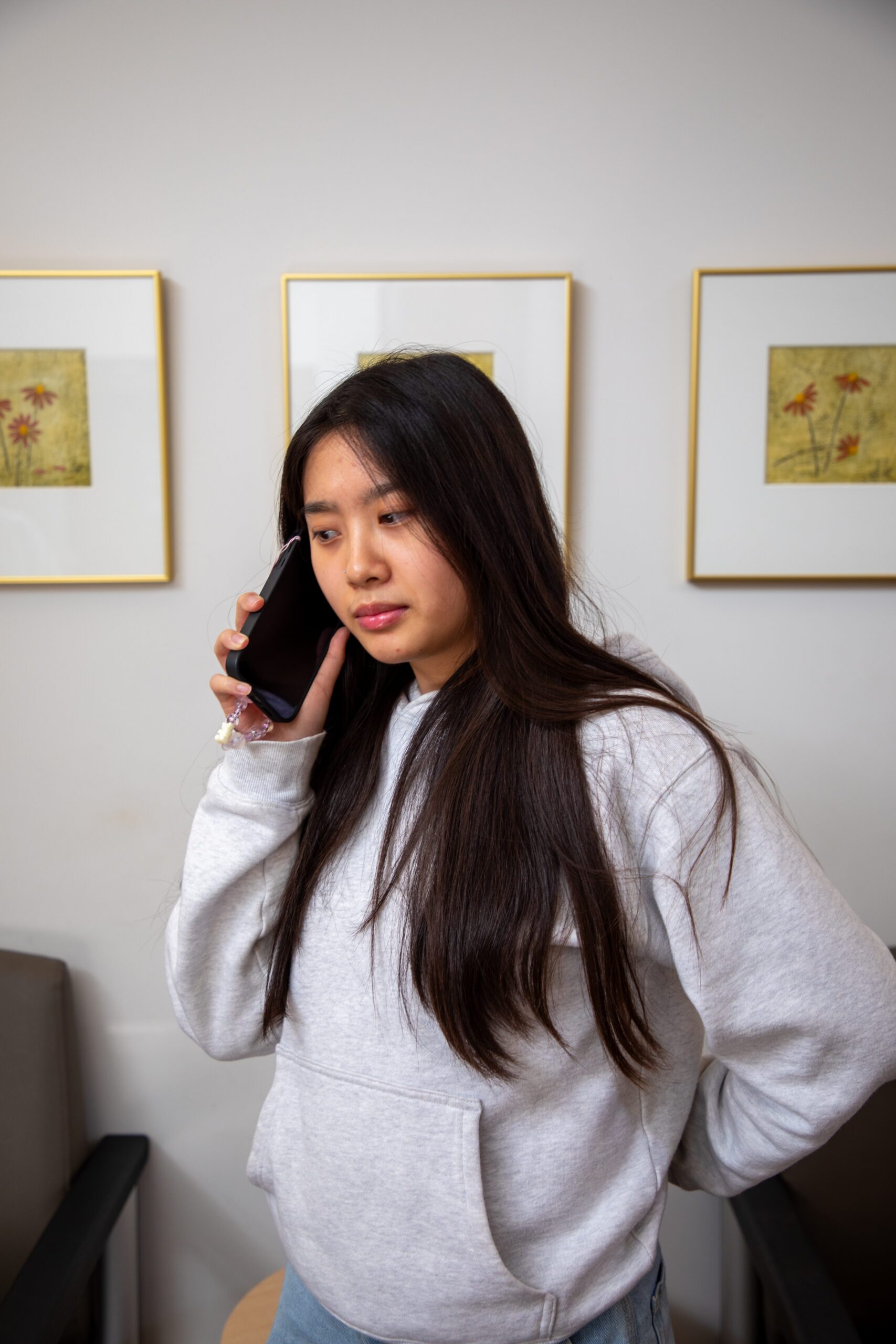 A woman holding a cell phone making a phone call.